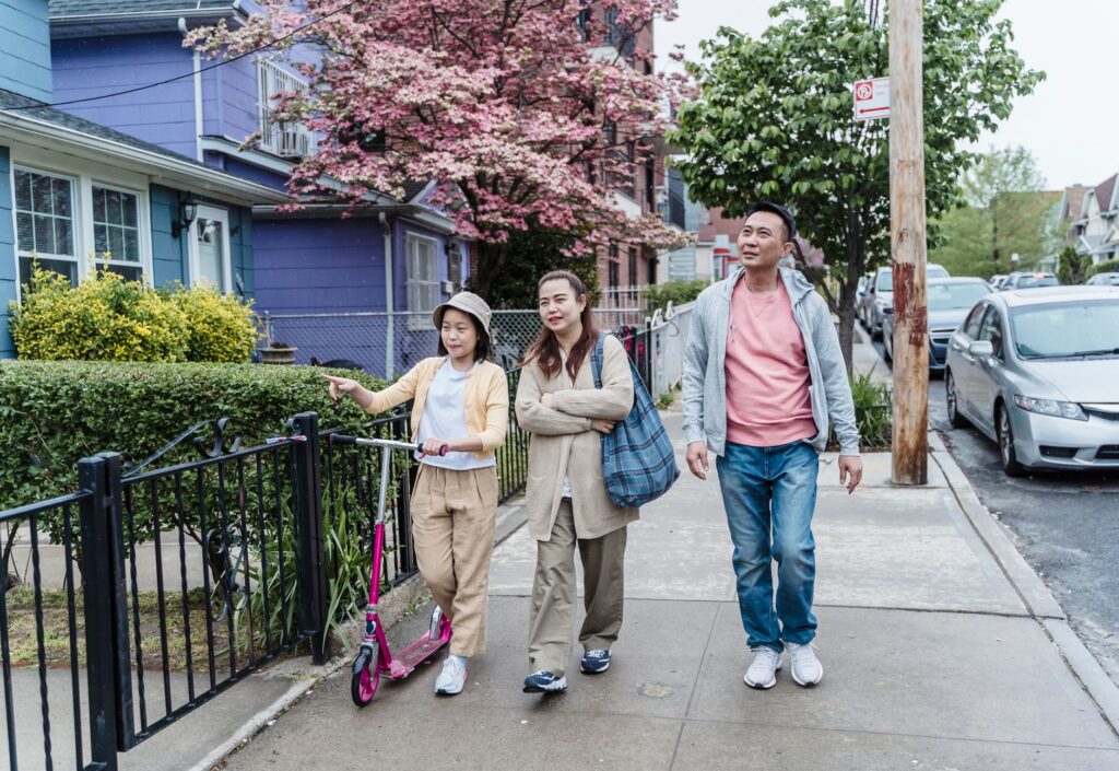 Family walking together on a pleasant day in a vibrant urban neighborhood.